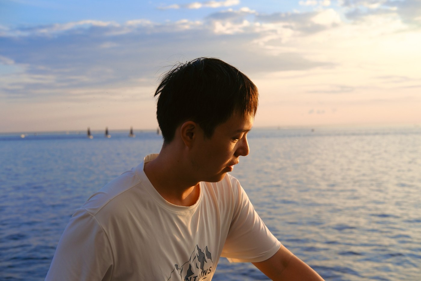 Jiesong Zhang by the sea at sunset